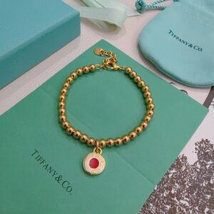 Tiffany & Co. Gold Beaded Bracelet with Red Charm